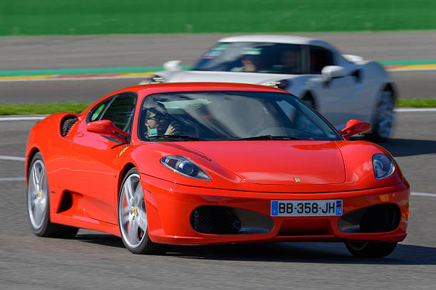 Ferrari F430 sports car front view Spa, Belgium - September 27, 2015 :Ferrari F430 sports car driving on the Spa Francorchamps race track. An Alfa Romeo 4C sports car is following in the background.The car is driving around the race track during the 2015 Spa Italia event at the Spa Francorchamps race track.  ferrari ferrari f430 italian culture action stock pictures, royalty-free photos & images