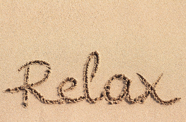 istock Word Relax handwritten on sand 518023988