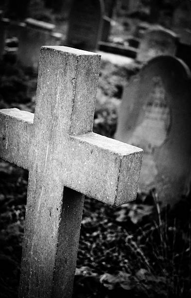 istock Stone cross seen standing in a cemetery. 518025876