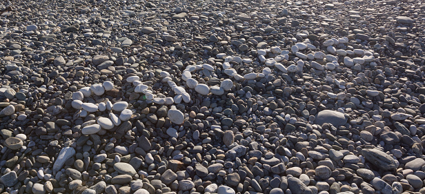 The sign Success made from white pebbles on pebble beach on the sea