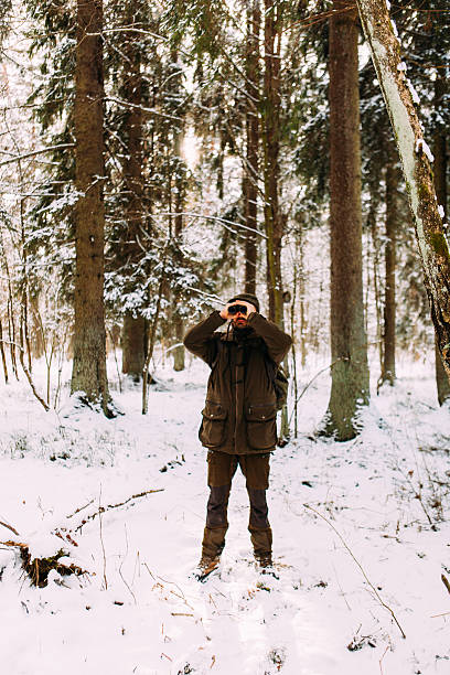 istock Forest Hiker On The Look Out In A Winter Forest 518026488