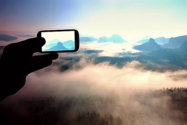 istock Smart phone mobile photography, mountains misty spring day 518028004