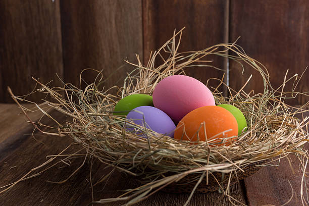 istock Easter eggs in nest on old wooden background 518028856