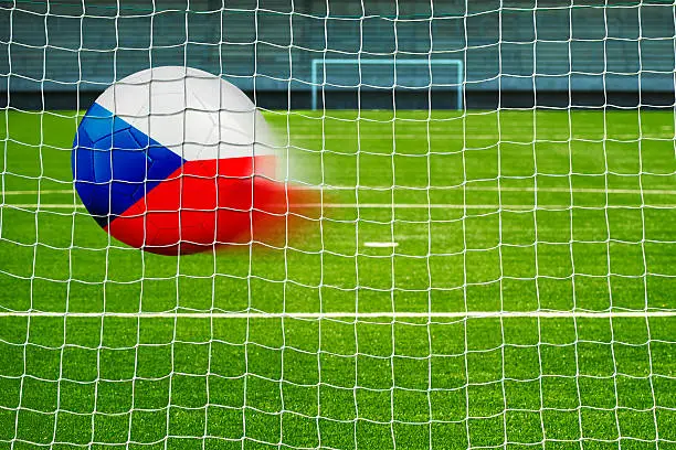 Shot on goal, soccer ball with the flag of Czech republic in the net