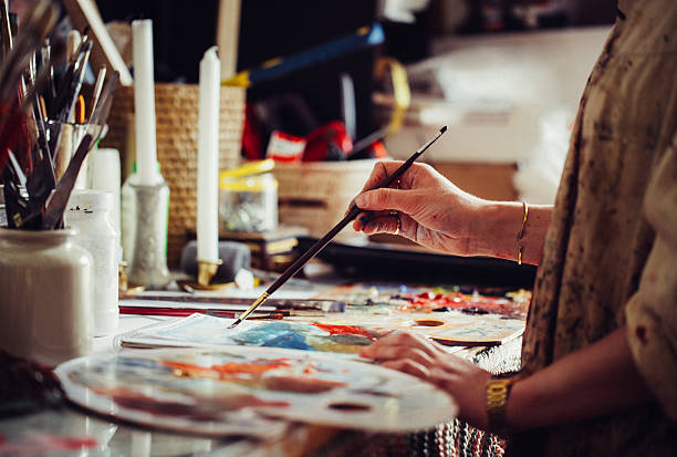 istock Artist painting at a table with a colourful palette 518030802