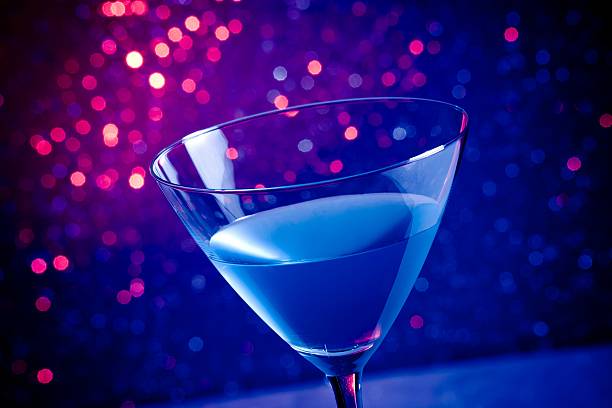 istock glass blue cocktail on blue and violet tint light background 518031940