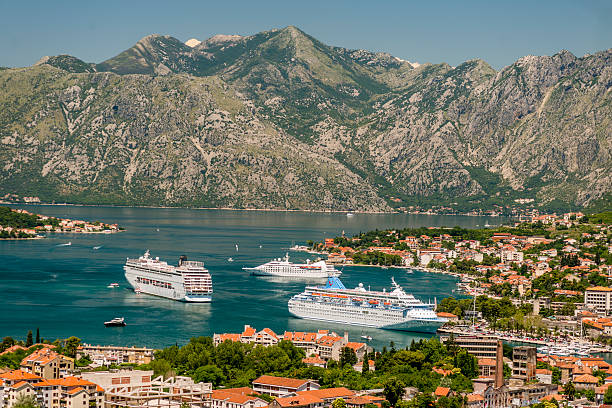 Kotor, Montenegro - July 7, 2014: MSC cruises - Armonia, TUI - Thomas Majesty and small cruise liner in front of Old Town Kotor. Ship names and 