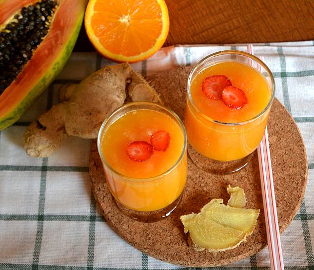 istock Healthy fresh orange, papaya and ginger smoothie. Top view. 518032952