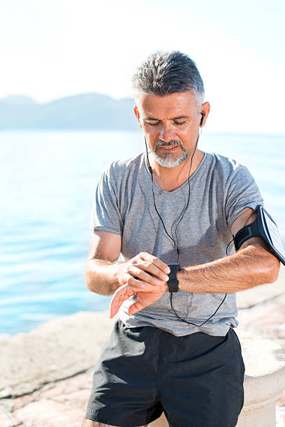 istock Runner looking at sport watch 518033374
