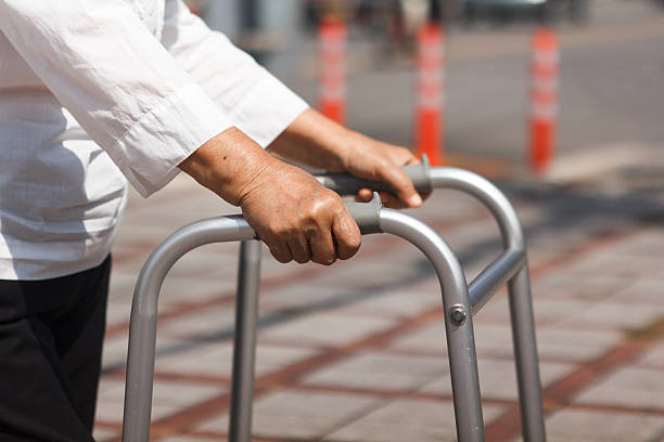 istock Senior woman using a walker cross street. 518037583