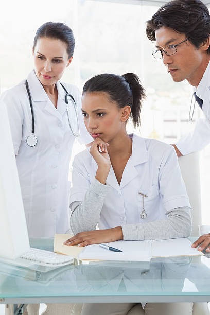 istock Doctors looking at a computer monitor 518037673