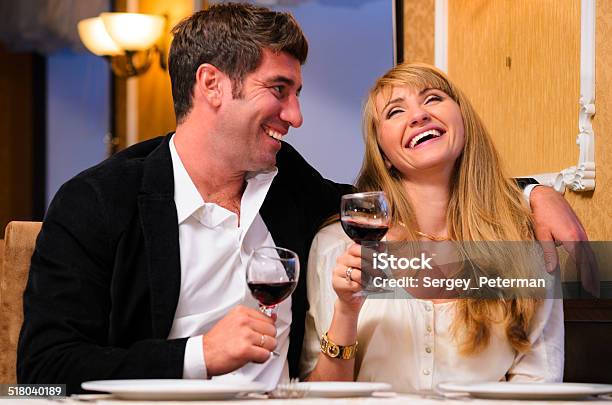 Couple Is Sitting At Restaurant Stock Photo - Download Image Now - Adult, Beautiful People, Beauty