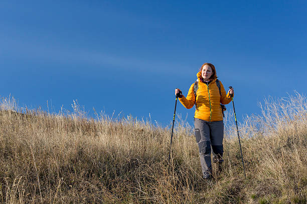 istock Female hiker walks downhill 518040719