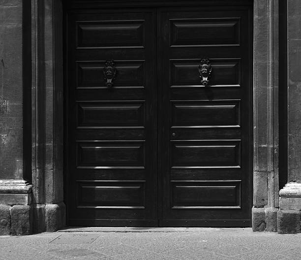old door in Catania, Sicily, Italy, taken in spring, architecture, travel, sunny day, vintage, black and white, monochrome
