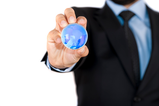 Business man holding a blue globe in his hand symbol for global business, communications or environmental conservation