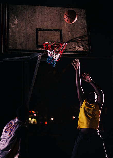 istock Basketball Player Throwing Ball into Basket 518056036