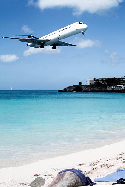 istock Airplane is flying low over the beach 518057960