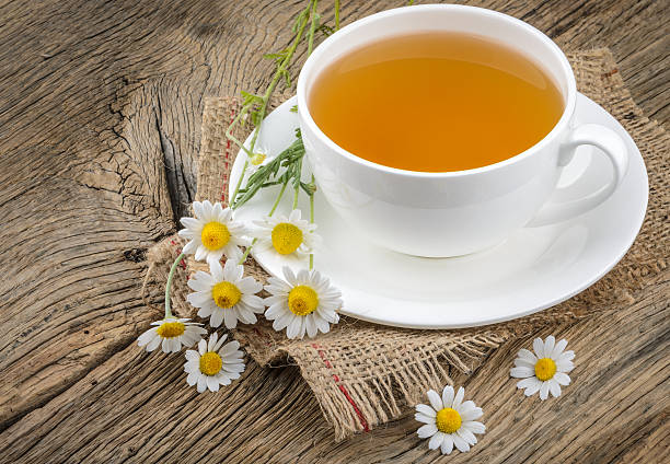 istock Cup of tea and chamomiles 518058416