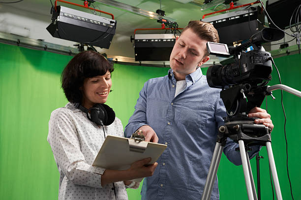 istock Cameraman And Floor Manager In Television Studio 518059014