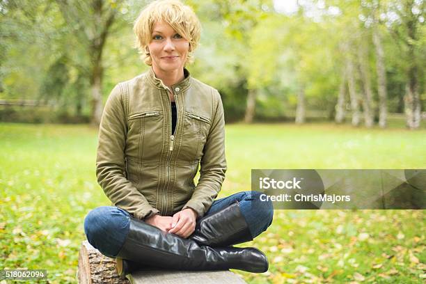 Beautiful Smiling Mid 30s Woman Sitting Crosslegged Stock Photo - Download Image Now
