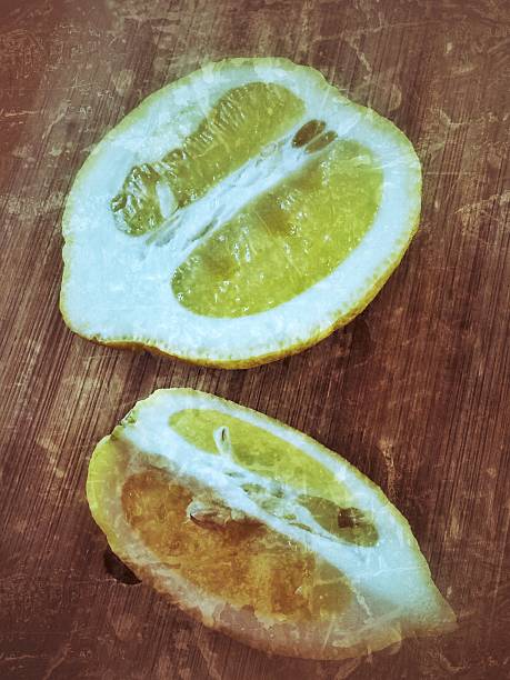 istock Vintage Fresh sliced lemon on wooden table. Top view 518062646