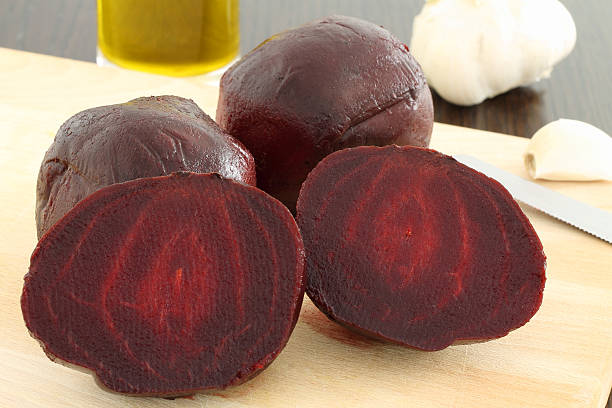 istock Cooked beetroot on wooden chopping board 518063082