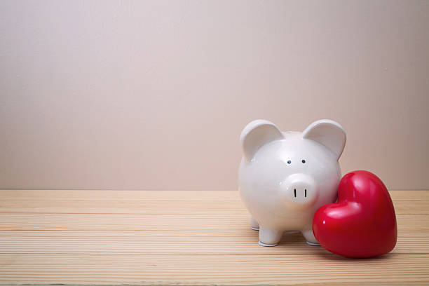 istock Piggy bank with red heart 518063322
