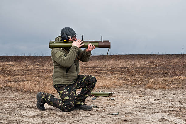 istock officer special operations forces shoots from a grenade launcher 518064234