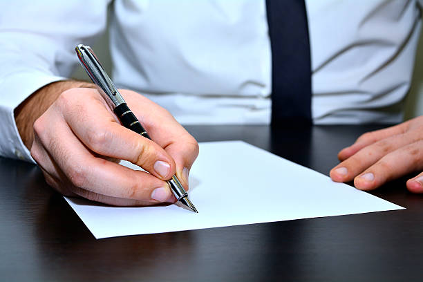 istock Business man writing on paper 518065676