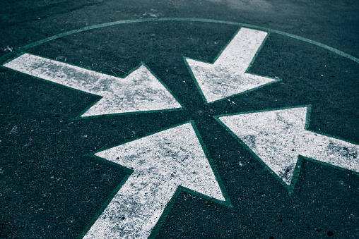 four arrows on asphalt on the street