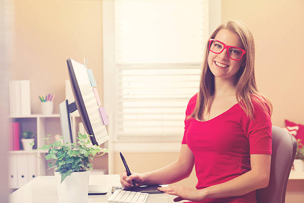 istock Young woman working with a pen tablet in her home 518066968