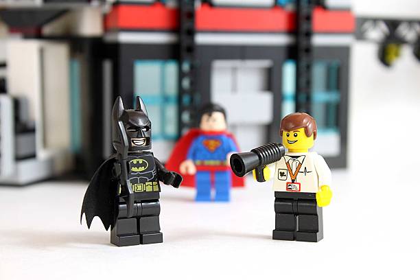 Action! Colorado, USA - March 25, 2016: Studio shot of LEGO minifigure Batman, Superman, and a movie director with building in background. superman named work stock pictures, royalty-free photos & images