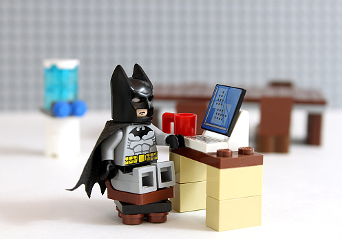 Colorado, USA - March 25, 2016: Studio shot of LEGO minifigure Batman working at a desk.