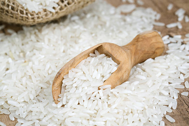 istock rice in a burlap bag on wooden surface 518085284