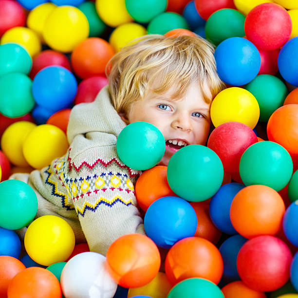 istock child playing at colorful plastic balls playground 518085450