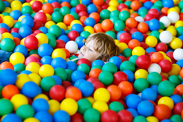 istock child playing at colorful plastic balls playground 518085542