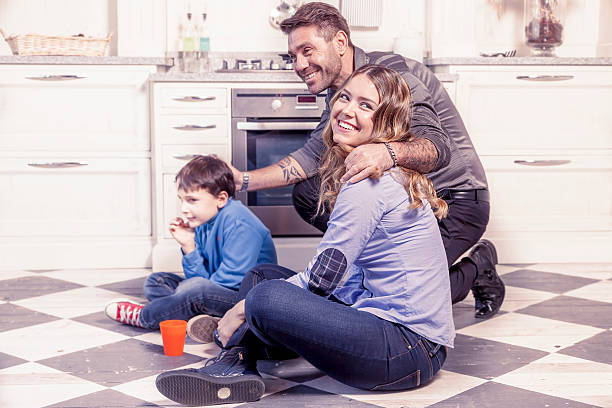 istock family relaxing on floor in the kitchen 518086422