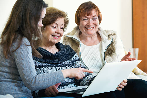 istock Female pensioners and relative browsing web on laptop 518086942