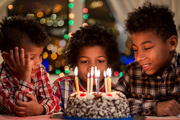istock Kids sitting beside birthday cake. 518086986
