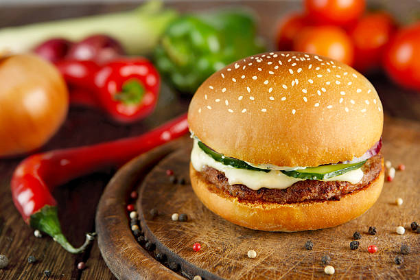 istock Meet and cheese burger at wooden desk 518087372