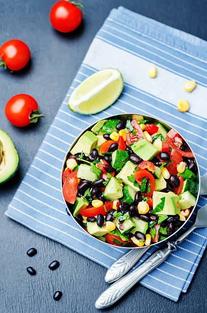 istock Black beans corn avocado cucumber tomato salad with lime dressing 518088280