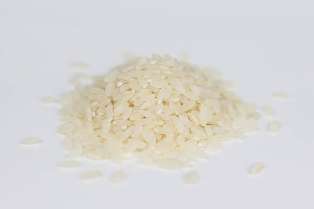 istock pile of  rice isolated on white background, uncooked rice 518088290