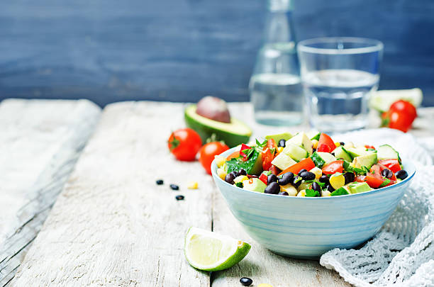istock Black beans corn avocado cucumber tomato salad with lime dressing 518088310