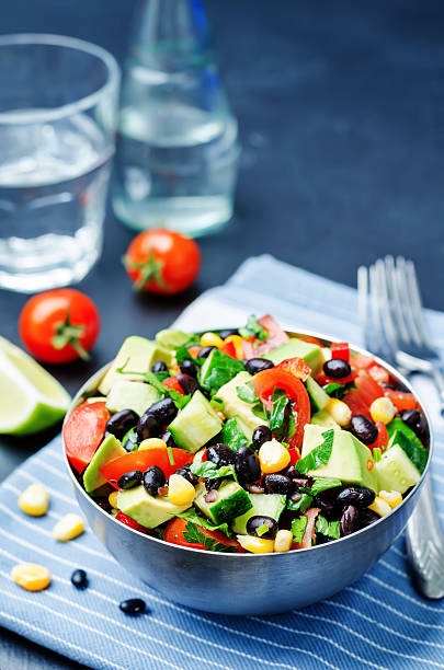 istock Black beans corn avocado cucumber tomato salad with lime dressing 518088388