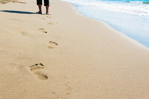 footprints of a man walking on the beach