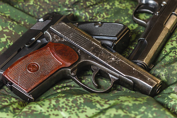 istock semi-automatic pistols on pixel camouflage background 518090024