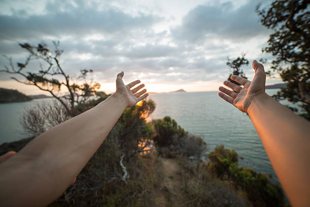 istock Woman's arms stretch towards the sun setting on Hauraki Gulf-NZ 518091284
