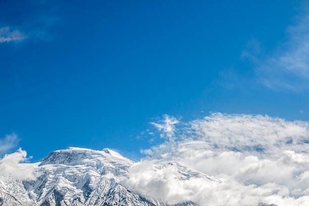 istock Mountain top covered with snow and clouds 518092186