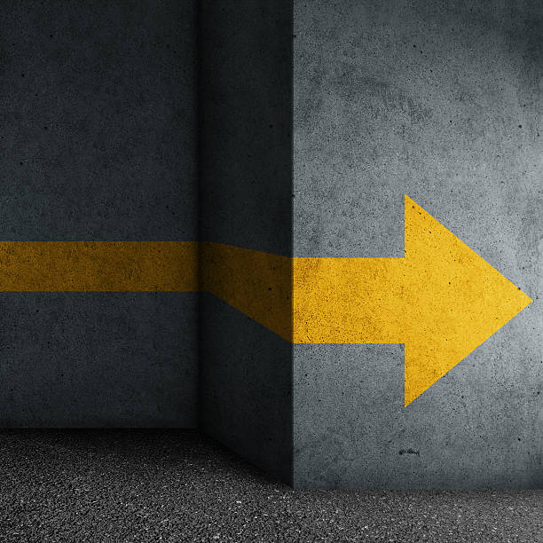 Abstract concrete block with yellow arrow sign