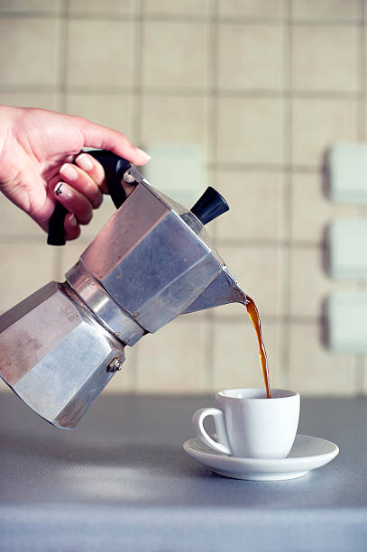 istock Hand close up pouring espresso coffee in a cup 518094997